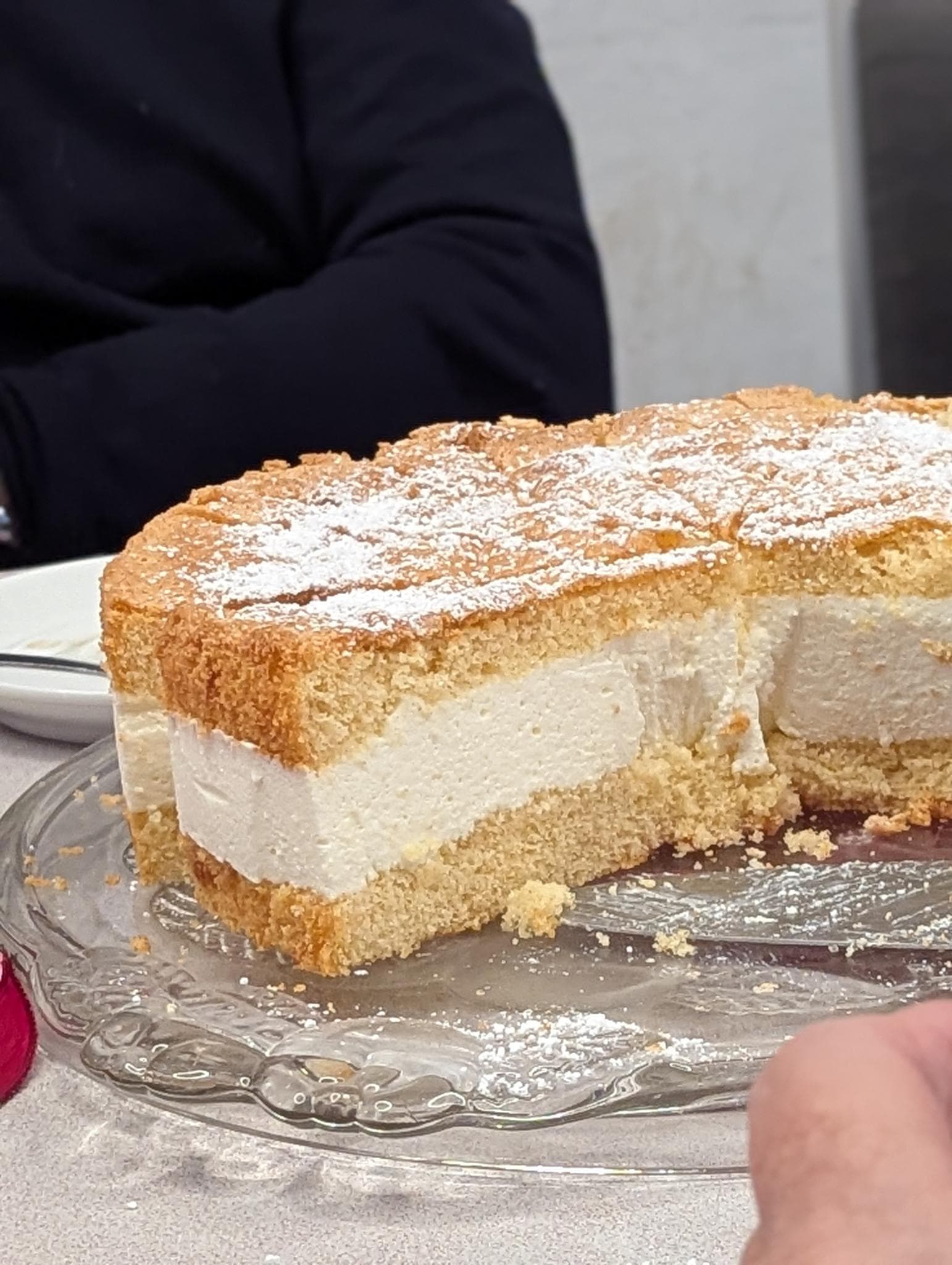 Angeschnittene Käsesahnetorte auf einer Glasplatte